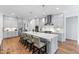 An elegant, modern kitchen with stainless steel appliances and a large island with bar stool seating at 6816 Rainwater Rd, Raleigh, NC 27615