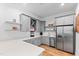Open kitchenette with gray cabinetry, stainless steel appliances, and light countertops at 6816 Rainwater Rd, Raleigh, NC 27615