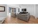 Open concept living area with hardwood floors, comfortable seating, and sliding glass doors to the outside at 6816 Rainwater Rd, Raleigh, NC 27615