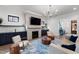 Cozy living room with a fireplace, built-in shelving, and comfortable seating at 6816 Rainwater Rd, Raleigh, NC 27615