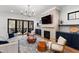 Bright living room with a fireplace, built-in cabinets, and access to an outdoor patio at 6816 Rainwater Rd, Raleigh, NC 27615