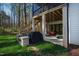 Outdoor patio with a swing, grill, and wooded views at 6816 Rainwater Rd, Raleigh, NC 27615