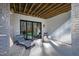 A covered patio featuring lounge chairs and sliding glass doors offering a relaxing outdoor living space at 6816 Rainwater Rd, Raleigh, NC 27615