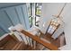 A beautifully designed staircase with wood steps leads to the front door, illuminated by a modern chandelier at 6816 Rainwater Rd, Raleigh, NC 27615