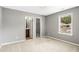 This carpeted bedroom has a view of the bathroom, closet, and features a window at 8000 Caithness St, Raleigh, NC 27616