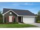Charming single-story home with a well-manicured lawn, attached garage, and complementary window shutter accents at 83 Orchard St, Lillington, NC 27546