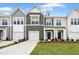 Charming townhome exterior featuring well-manicured lawn and attached one car garage at 88 Ripple Way # 314, Clayton, NC 27520