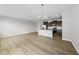 Open-concept living area featuring kitchen with center island and hardwood floors at 88 Ripple Way # 314, Clayton, NC 27520