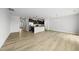 Open-concept living area with kitchen island and wood floors at 88 Ripple Way # 314, Clayton, NC 27520