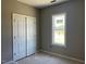A bedroom features a closet and one window with a view of the outside at 896 Olive Branch Dr, Smithfield, NC 27577
