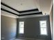 A bedroom featuring a decorative trey ceiling with two windows providing natural light at 896 Olive Branch Dr, Smithfield, NC 27577
