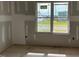A bedroom with drywall and a window that lets in natural light and a view of the neighborhood at 896 Olive Branch Dr, Smithfield, NC 27577
