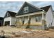 Charming house with covered front porch, steps, white siding, dark grey shutters, and a detached garage at 896 Olive Branch Dr, Smithfield, NC 27577