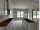 Bright kitchen area with unfinished white cabinets and island at 896 Olive Branch Dr, Smithfield, NC 27577