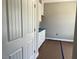 A new laundry room with white cabinets, blue countertops and a white door at 896 Olive Branch Dr, Smithfield, NC 27577
