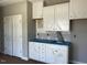 A new laundry room featuring white cabinets and blue countertops at 896 Olive Branch Dr, Smithfield, NC 27577