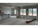 Open-concept living room and kitchen with large windows and unfinished drywall at 896 Olive Branch Dr, Smithfield, NC 27577