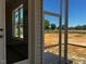 A screen porch with door leading inside and views of the backyard at 896 Olive Branch Dr, Smithfield, NC 27577