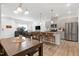 Open concept kitchen and living room with gray cabinets and bar seating at 953 Robbie Jackson Ln, Fuquay Varina, NC 27526