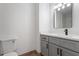 Bathroom featuring gray vanity, modern black fixtures, and a toilet at 1016 N Bend Dr, Raleigh, NC 27609