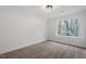 Bedroom showcasing a large window with wooded backyard views and neutral carpet at 1016 N Bend Dr, Raleigh, NC 27609