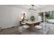 Modern dining room featuring contemporary furniture, stylish lighting, and sliding glass doors to the backyard at 1016 N Bend Dr, Raleigh, NC 27609