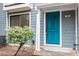 Close up view of the teal blue front door with a window to the left at 1016 N Bend Dr, Raleigh, NC 27609