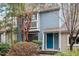Charming two-story home with a blue exterior, a small balcony, and mature landscaping at 1016 N Bend Dr, Raleigh, NC 27609