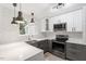 Well-lit kitchen with stainless steel appliances, subway tile backsplash, and white and gray cabinets at 1016 N Bend Dr, Raleigh, NC 27609