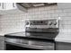 Stainless steel range and oven with white subway tile backsplash and modern appliances at 1016 N Bend Dr, Raleigh, NC 27609