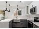 Bright kitchen with subway tile backsplash, stainless steel sink, and modern light fixtures at 1016 N Bend Dr, Raleigh, NC 27609