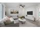 Bright living room featuring a modern sofa, neutral walls, and a ceiling fan at 1016 N Bend Dr, Raleigh, NC 27609