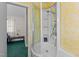 Bathroom features a shower and tub unit with built in shelving for storage at 104 Seaman St, Oxford, NC 27565