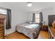Bedroom features windows, a queen bed, and hardwood floors at 104 Seaman St, Oxford, NC 27565