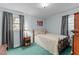 This bedroom features a light blue color scheme with carpet, and plenty of natural light at 104 Seaman St, Oxford, NC 27565