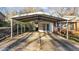 Spacious carport offering covered parking next to a charming brick home at 104 Seaman St, Oxford, NC 27565