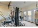 Bright exercise room equipped with a multi gym, weights, and access to the backyard at 104 Seaman St, Oxford, NC 27565