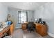 Well-lit home office space includes wooden desk, office chair, and gray walls at 104 Seaman St, Oxford, NC 27565