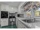Well-lit kitchen showcases marble countertops, stainless steel appliances, and ample storage at 104 Seaman St, Oxford, NC 27565
