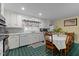 Bright kitchen features white cabinetry, a dining table, and cheerful decor at 104 Seaman St, Oxford, NC 27565