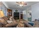 Welcoming living room featuring plush sofas, a ceiling fan, and a view into the kitchen at 104 Seaman St, Oxford, NC 27565