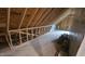 Unfinished attic space showing exposed wooden beams, and ready for customization at 105 Leisure Ln, Louisburg, NC 27549
