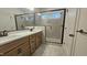 Bathroom featuring double vanity, tiled shower with glass door, and stylish fixtures at 105 Leisure Ln, Louisburg, NC 27549