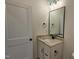 Half bathroom with granite countertop and modern sink, plus stylish mirror and lighting at 105 Leisure Ln, Louisburg, NC 27549
