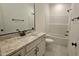 Bathroom featuring a granite countertop vanity with black fixtures, a white tub, and a toilet at 105 Leisure Ln, Louisburg, NC 27549