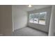 This bedroom features plush gray carpeting, and a large window providing a view of the outdoors at 105 Leisure Ln, Louisburg, NC 27549
