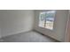 Cozy bedroom with soft carpet, a large window, and fresh, neutral paint at 105 Leisure Ln, Louisburg, NC 27549
