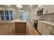 Bright dining area with a chandelier, exposed beams, hardwood floors, and natural light at 105 Leisure Ln, Louisburg, NC 27549