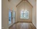 Bright dining room with hardwood floors, modern chandelier, and access to outdoor deck at 105 Leisure Ln, Louisburg, NC 27549