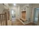 Inviting entryway with custom built-in bench, hardwood floors, and access to multiple rooms at 105 Leisure Ln, Louisburg, NC 27549